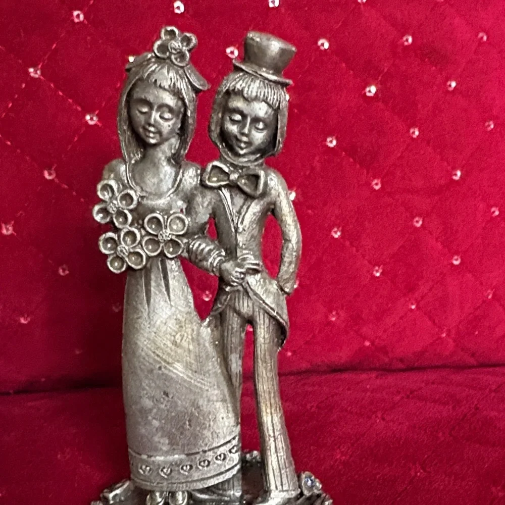 This is a vintage Italian Peltro pewter bride and groom figurine.